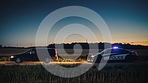 Speeding Driver Gets Pulled Over By Police Patrolling Car During Sunset. Wide Shot of the Two Cars