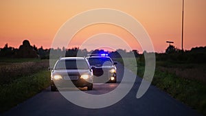 Speeding Driver Gets Pulled Over By Police Patrolling Car . Wide Shot of the Two Cars Stopped in a