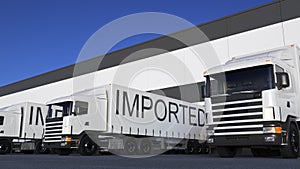 Speeding freight semi truck with IMPORTED caption on the trailer loading or unloading