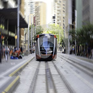 Speeding Passenger Tram Train moving through Station in Sydney CBD NSW Australia