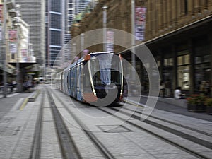 Speeding Passenger Tram Train moving through Station in Sydney CBD NSW Australia