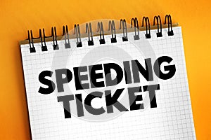 Speeding ticket - a ticket issued for driving above the speed limit, text concept on notepad