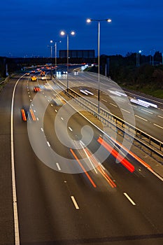 Speeding traffic driving along the M5 motorway at night.
