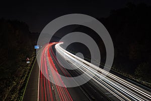 Speeding traffic on M40 motorway leaves light trails from fast moving cars.