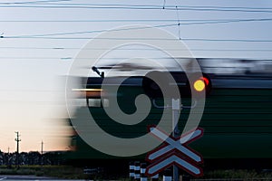 Speeding train passing a level crossing