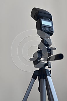 Speedlight gun with trigger set mounted on tripod