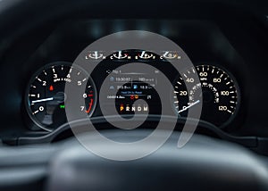 Speedometer of a new modern car with an integrated fuel gauge in the tank with blue arrows. Starting engine, with