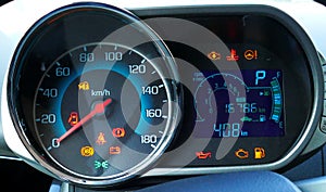 Speedometer and tachometer with additional instruments on car dash