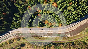 A speedway winding along mountainous landscape with seasonal forest