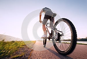 Speedy bicyclist wide angle wheel view