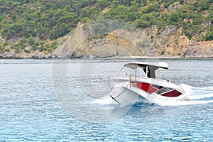 Speedy motorboat goes by the sea