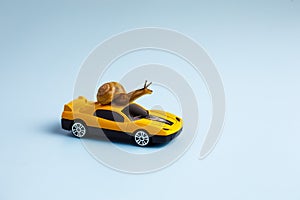 Speedy snail like car racer. Concept of speed and success. Concept of fast taxi or delivery. Yellow car blue background