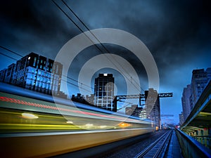 Speedy Train and Modern City at night