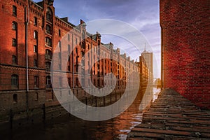 Speicherstadt warehouse district during sunset in Hamburg, Germany. Old brick buildings of Hafencity quarter. UNESCO