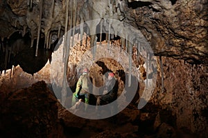 Speleologist in a cave with calcite incrustations