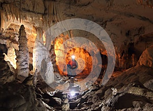 Speleologist exploring the cave photo