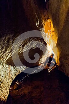 Speleologist exploring a deep cave