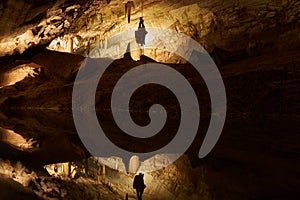 Speleologist Hanging On A Rope In A Cave