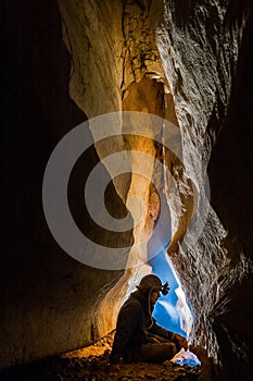 Speleologist taking a rest during cave exploration