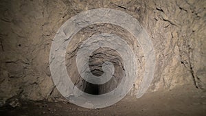 Speleology artificial cave dark tunnel excavation underground. Old adit for the extraction of metal and rocks
