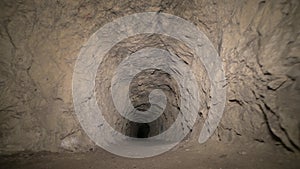 Speleology artificial cave dark tunnel excavation underground. Old adit for the extraction of metal and rocks