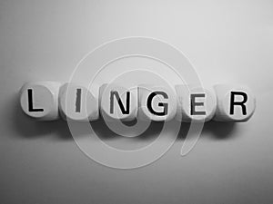 Word linger spelled on dice
