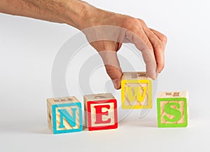 Spelling the Word News with Coloful Blocks