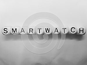 Word smartwatch spelled on dice