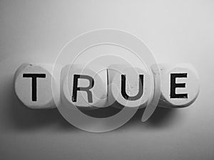 Word true spelled on dice