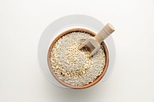 Spelt bran and grains in clay pot isolated on white background