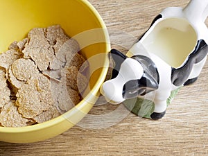 Spelt cereals in a bowl and milk