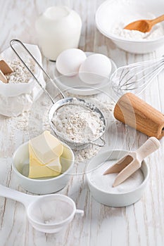 Spelt flour, sugar with baking ingredients and kitchen utensils