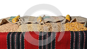 Spelt, soybean, wheat grains and corn kernels in jute sacks.