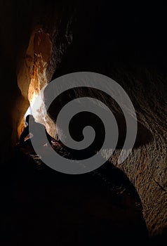 Spelunker exploring a cave photo