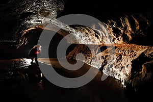 Spelunker exploring the cave photo