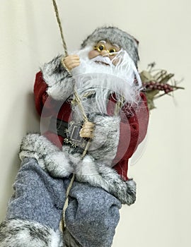 A Spelunking Santa Claus runs down an office wall