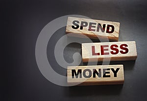 Spend Less Money on wooden blocks, Financial concept. Selective focus
