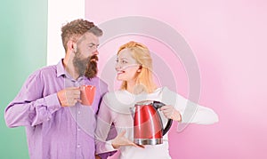 Spending good morning together. Couple prepare morning drink electric kettle device. Electric kettle boils water very
