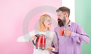 Spending good morning together. Couple prepare morning drink electric kettle device. Electric kettle boils water very