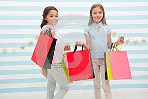 Spending great time together. Children satisfied shopping striped background. Obsessed with shopping and clothing malls