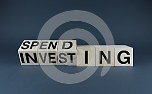 Spending - Investing. Cubes form the words Spending - Investing