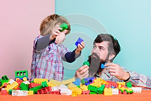 Spending nice time at home. building with colorful constructor. happy family leisure. father and son play game. love