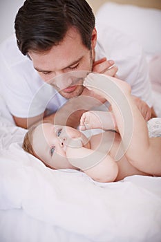 Spending special time together. A devoted young dad spending time with his baby daughter.