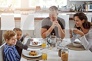 Spending time as a family. a family having breakfast together.