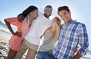 Spending time with great friends. Cropped portrait of two happy couples enjoying a day at the beach.