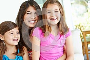 Spending time with mom. Portrait of a pretty young mother spending time with her two cute daughters.