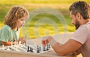 spending time together. strategic and tactic. tutorship. dad and kid play logic game.