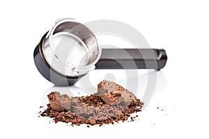 Spent or used coffee grounds with portafilter at the background photo