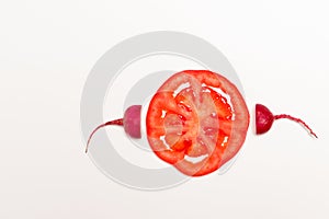 Sperm swimming toward to egg concept. crimson giant red radish and red tomato vegetable