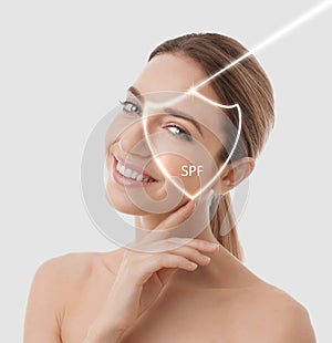 SPF shield and young woman with healthy skin on white background. Sun protection cosmetic product